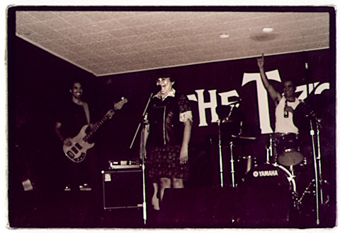 Local woman sings a Spanish song while the Peek Show takes a break during the Dog Rescue Benefit at Mr. T's in Highland Park Nov. 2, 2001.9