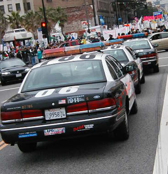 Black and White Squad Cars wait for Trouble
